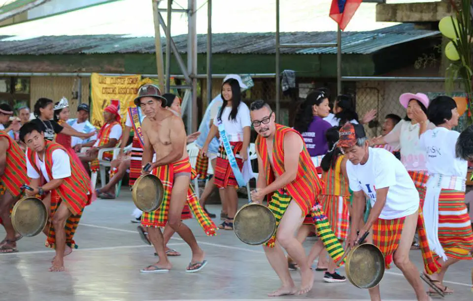 Locals in Lias showing the Igorot Costume for Male and Females during a cultural festival.